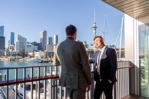 128140-two-male-delegates-conversate-web-optimised-2560px-webp